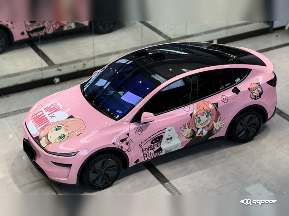 Elevated front three-quarter view of a pink car with SPY x FAMILY Anya and Bond artwork on the hood and side panels.